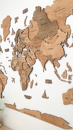 a wooden world map is shown on the wall