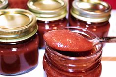 several jars filled with jam sitting on top of a table