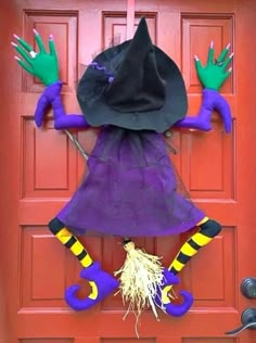 a door decorated for halloween with witch hands and legs