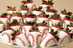 a platter filled with baseball and strawberry covered strawberries