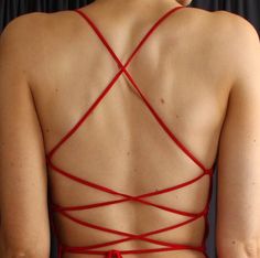 the back of a woman's bra with red stringing on her chest and bottom