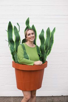 a woman wearing a potted plant costume