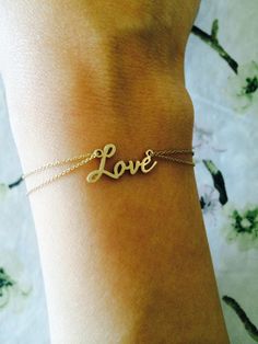 "Elegant LOVE Bracelet in 14k SOLID gold on a double chain. Can also be made with other words. The love signature is made in modern script for an elegant style. It is sturdy with an approximate 1mm thickness. - Bracelet Length 7\" - The measurement of the first letter is approx. 7mm in height and the lowercase letters are approx. 3mm in height - Made in New York - Sending as a gift? Comes with gift box. Makes a perfect push present or gift for any mom, sister, girlfriend or wife! This item takes Elegant Sterling Silver Name Bracelet For Valentine's Day, Elegant Personalized Bracelets For Anniversary Gift, Gold Delicate Name Bracelet For Anniversary, Delicate Gold Name Bracelet For Anniversary, 14k Gold Bracelet For Wedding On Valentine's Day, Elegant Name Bracelet For Valentine's Day, Elegant Personalized Name Bracelet For Anniversary Gift, Elegant Personalized Name Bracelet For Anniversary, Gold Bracelet For Anniversary Gift