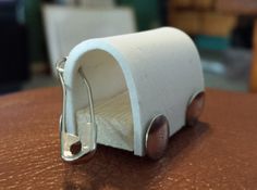 a small white object sitting on top of a wooden table