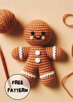 a crocheted ginger is next to a ball of yarn and a knitting needle