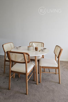 a white table with four chairs around it