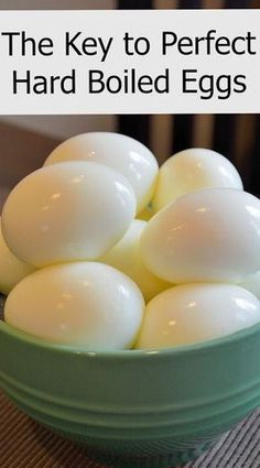 a green bowl filled with hard boiled eggs