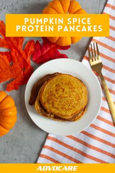 pumpkin spice protein pancakes on a white plate with fork and orange striped napkin next to it