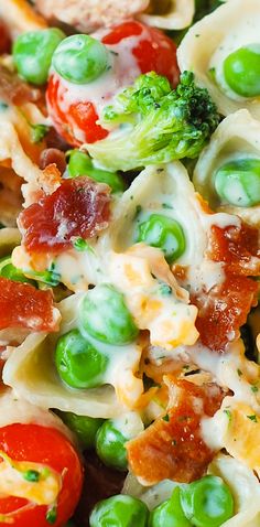 a pasta salad with peas, tomatoes and broccoli