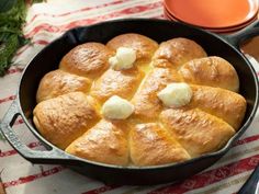 a pan filled with bread and butter on top of a table