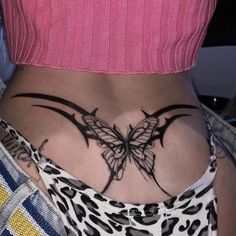 a woman's stomach with a butterfly tattoo on her lower back and bottom part