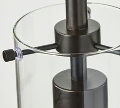 a close up of a glass and metal object with a light on the bottom part