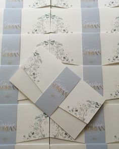 the wedding stationery is laid out on top of each other