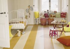 a child's room with yellow and white stripes on the floor