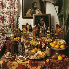 a table topped with lots of different types of food and drinks next to a painting