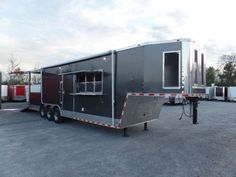 a trailer parked in a parking lot next to other trailers and trucks with windows on the side