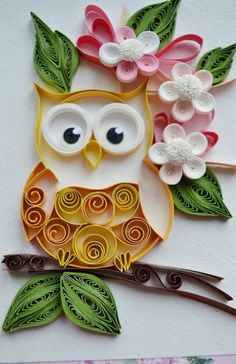 an owl is sitting on a branch with flowers