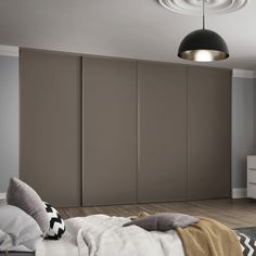 a bedroom with a bed, dresser and sliding closet doors in the middle of it