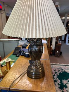 an owl lamp sitting on top of a wooden table