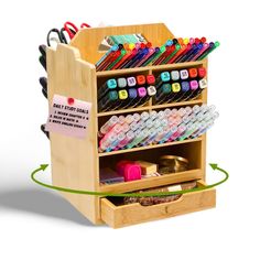 a wooden desk organizer with lots of pens and pencils