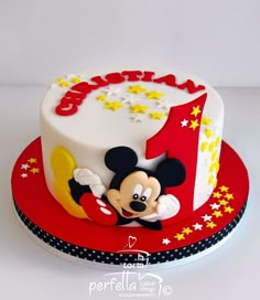 a mickey mouse birthday cake with the number one on it