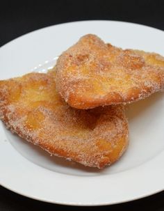 three sugar coated donuts on a white plate