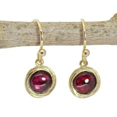 Garnet dangle earrings The garnet is January's birthstone, and it symbolizes peace, prosperity and good health. Some say it even has the power to give the wearer eternal happiness, health and wealth. 🌸 Product details: Handmade earrings 🌸 Measurements: Weight - 2.2 g Length - 1.02" (2.6 cm) Width - 0.35" (0.9 cm) Stone Diameter - 0.23" (6 mm) 🌸Materials: 14k gold plating over brass Genuine garnet 🌸 More info: All my jewelry is carefully wrapped and shipped in a lovely gift box, ready to be g Single Ruby Earring As A Gift, Red Birthstone Earrings As Gift, Red Birthstone Earrings For Gift, Garnet Gemstone Drop Earrings, Nickel Free Ruby Earrings As A Gift, Nickel-free Ruby Earrings As A Gift, Nickel-free Ruby Earrings For Gift, Red Birthstone Drop Earrings, Garnet Drop Earrings With Matching Set