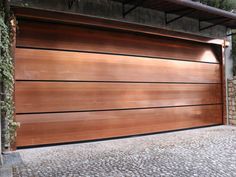 a large wooden garage door on the side of a building