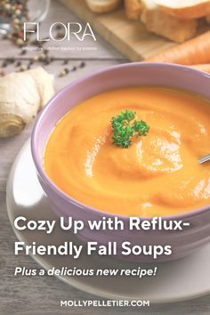 a purple bowl filled with soup on top of a white plate