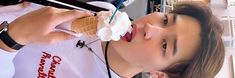 a woman is eating an ice cream cone