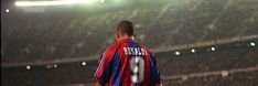 a soccer player standing in front of an empty stadium