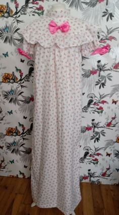 Stunning handmade nightgown, crafted from luxurious 100% Organic Cotton, soft and lightweight. Beautiful pink floral print. Retro vintage style with yoke and ruffle. Puffed sleeves. High Couture French seam which is  neat inside and soft on the skin. Lovely bow trims and ruffle. Measurements: Bust up to 46" Length 58" f Pink Floral Print Short Sleeve Sleepwear, Short Sleeve Floral Print Nightgown For Home, Feminine Ruffled Short Sleeve Sleepwear, Floral Print Short Sleeve Dress For Pajama Party, Pink Ruffled Short Sleeve Sleepwear, Pink Ruffled Sleepwear, Pink Floral Print Short Sleeve Nightgown, Pink Floral Print Nightgown With Short Sleeves, Pink Fitted Ruffle Sleepwear