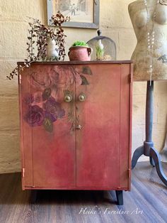 a pink cabinet with flowers painted on it