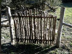 an old wooden fence in the middle of a field