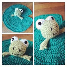 crocheted frog sitting on top of a green mat with two eyes and one nose