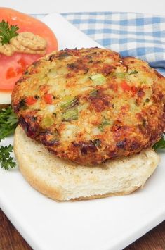 there is a sandwich on the plate with tomatoes