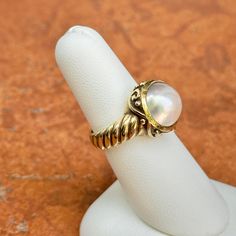 New, but old pieces, never worn, recently acquired from a premier jeweler located in Minneapolis, MN for many years- A rare opportunity! 14KT yellow gold genuine, bezel-set, Mabe pearl ring with Etruscan/ filigree design. Size 6.25 Sizable by us for a fee or your local jeweler Weight: 7.90 grams Band width: 4mm 11mm pearl Stamped 14k Classic Yellow Gold Oval Cabochon Moonstone Ring, Classic Formal Cabochon Moonstone Ring, Elegant Gold Hallmarked Moonstone Ring, Elegant Gold Moonstone Ring Hallmarked, Heirloom High Luster Oval Pearl Ring, White Heirloom Jewelry With High Luster, Elegant White Domed Jewelry, Heirloom White Jewelry With High Luster, White High Luster Heirloom Jewelry