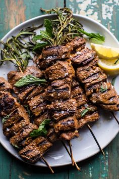 grilled meat with herbs and lemon on a plate