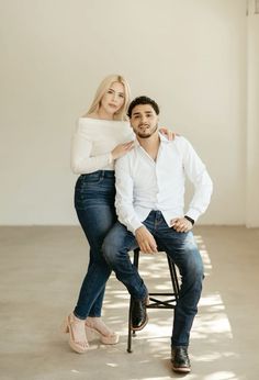 a man and woman are sitting on a chair