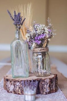 two vases filled with flowers sitting on top of a table