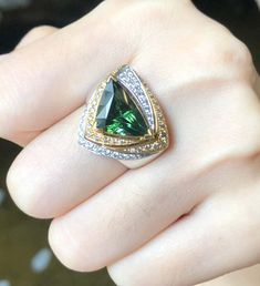 For Sale on 1stDibs - Green Tourmaline 4.14 carats with Brown Diamond 0.27 carat and Diamond 0.28 carat Ring set in 18 Karat White Gold Settings Width: 2.0 cm Length: 1.9 cm Luxury Trillion-cut Emerald Ring, Luxury Green Trillion Cut Jewelry, Luxury Tsavorite Gemstones For Anniversary, Luxury Tourmaline Gemstones With Accent Stones, Luxury Tourmaline Ring With Center Stone, Luxury Tourmaline Emerald Ring, Luxury Trillion-cut Sapphire Ring, Gia Certified Tourmaline Jewelry For Anniversary, Fine Jewelry Tourmaline With Brilliant Cut