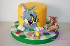 a cake that is decorated to look like an animated character with two mice on it