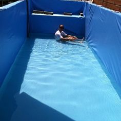 a man sitting in an empty swimming pool