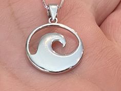 ".925 Sterling Silver Unisex High-polished Hawaiian Beach Ocean Wave Nalu Necklace. FREE Sterling Silver Italian Box Chain included In your choice of length. The size is smaller at 15MM, just above 1/2\". The Bail is 4MM. Handcrafted with attention to detail, the highly-reflective Sterling finish is both stunning and durable. This simple but substantial and unique Nalu design is a bestseller in our Hawaii stores. --Wave Jewelry was worn by ancient Hawaiians to give energy, courage, beauty and gr White Sterling Silver Jewelry With Shiny Finish, Sterling Silver Jewelry With Shiny Finish As A Gift, White Symbolic Jewelry With Polished Finish, Symbolic White Jewelry With Polished Finish, White Polished Sterling Silver Jewelry, White 925 Stamped Round Pendant Jewelry, Cadmium-free Round Silver Jewelry, Symbolic White Round Jewelry, White Round Pendant Jewelry Stamped 925