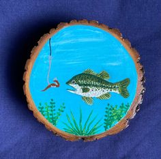 a fish is depicted on a piece of wood