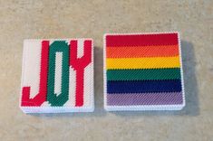 two small patches with the word joy on them, one in rainbow and the other in red