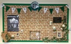 there is a brick wall decorated with green and white pennants, starbucks coffee signs, and photos on it