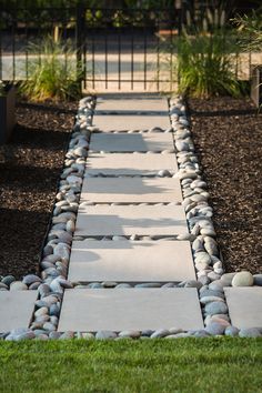 a walkway made out of stones and grass