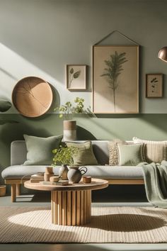 a living room filled with furniture and paintings on the wall next to a coffee table