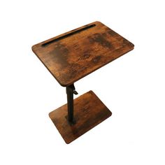 an old wooden table with metal legs and a tray on the top that holds a knife